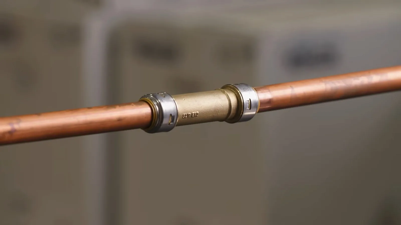 Copper pipe joined in the middle with a metal push coupling